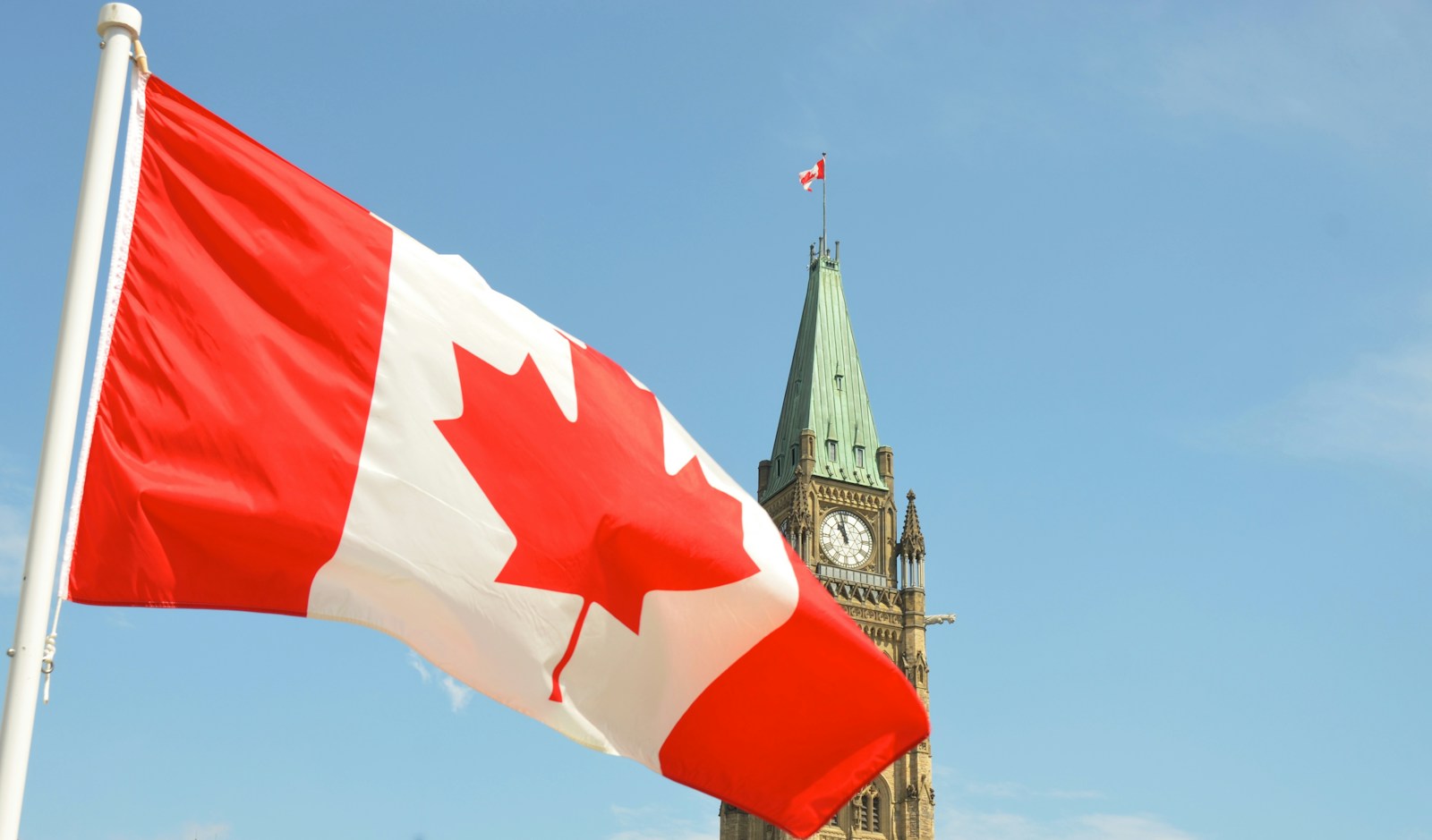 Canadian flag in front of the Peace Tower in Ottawa.